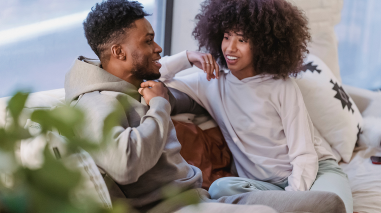 Couple practices active Listening in Relationships while sitting on couch together